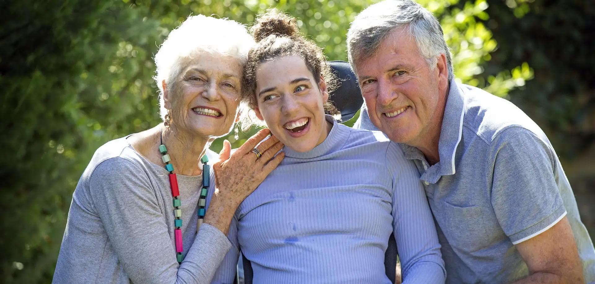 Family of 3 smiling, girl in the middle has meningitis
